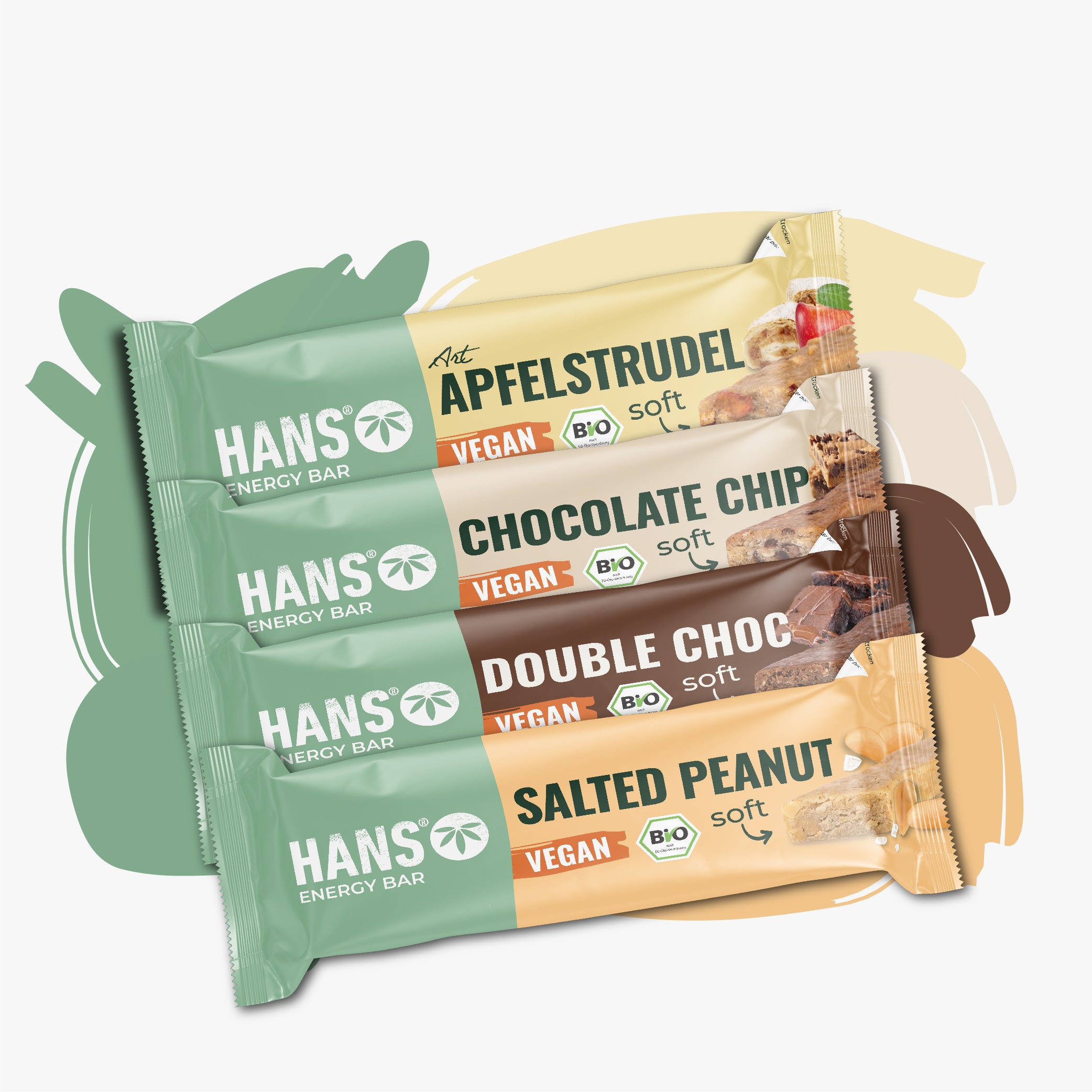 Produktový snímek představující čtyři veganské energetické tyčinky Hanso Apfelstrudel Chocolate Chip Double Choc a Salted Peanut v pastelových barevných obalech s viditelným složením a BIO etiketou.
