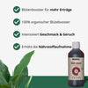 Produktfoto: Biobizz Top-Max, ein dunkler, organischer Blütebooster in einer Flasche mit einem roten Kreis auf dem Etikett, vor einem Hintergrund mit großen, grünen Blättern.
