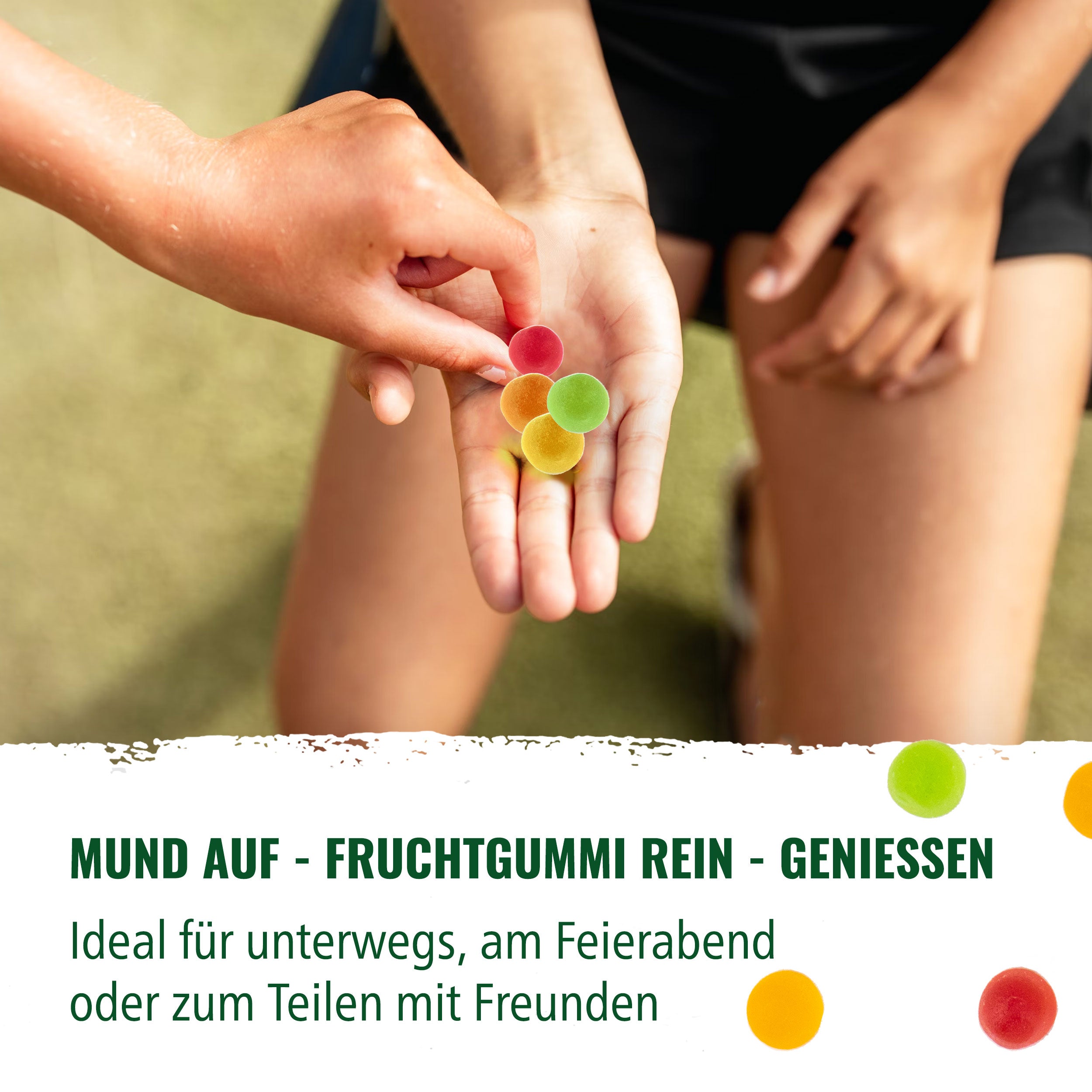 Photography: One hand holds colorful, round fruit gums in different colors such as red, yellow and green

