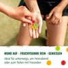 Photography: One hand holds colorful, round fruit gums in different colors such as red, yellow and green
