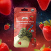 Bud Voyage product image: A packaging with Strawberry Haze CBD flowers in front of a starry background, surrounded by strawberries and with a rocket motif and a fruity, golden design.
