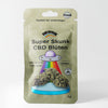 Bud Voyage product packaging shows Super Skunk CBD flowers with a UFO, rainbow and bright turquoise pedestal against a white background
