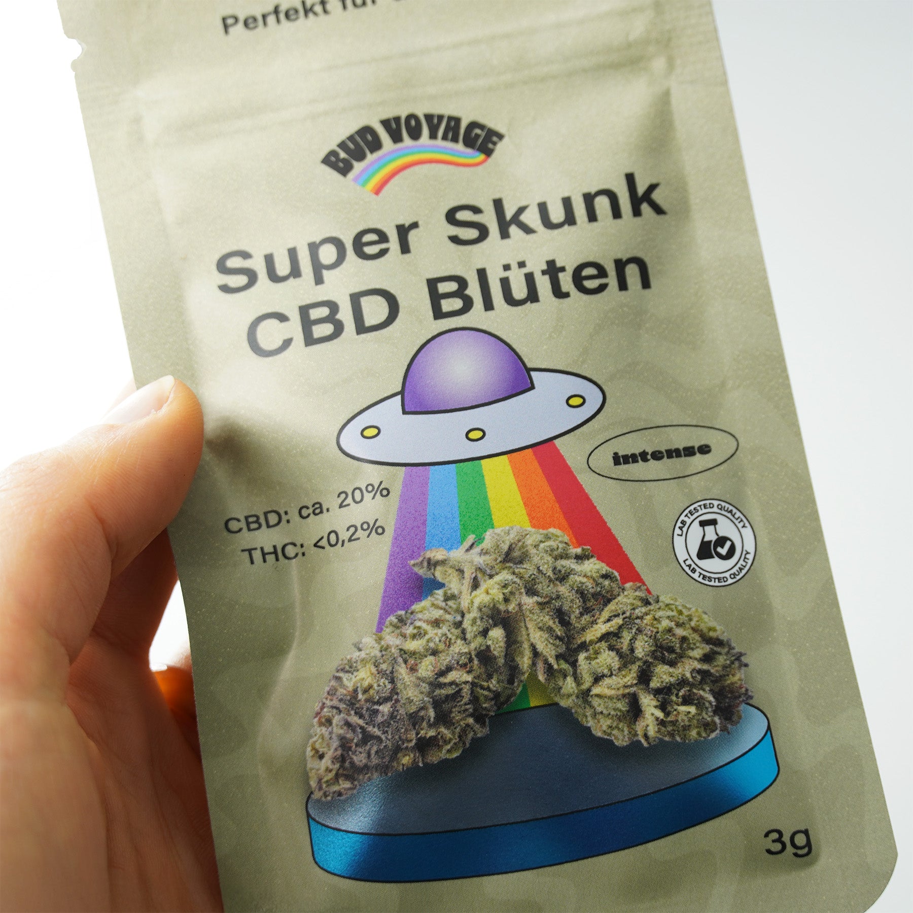 Bud Voyage packaging features Super Skunk CBD flowers with a UFO, rainbow and bright blue pedestal, 3g pack

