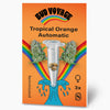 Bud Voyage graphic: Tropical Orange Automatic seeds in a test tube, surrounded by cannabis flowers and a rainbow on an orange background with a turquoise wave and three feminized seeds