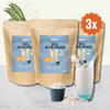 Product photo of Hans 85% Ultra Protein, three packs on a marble table with a glass of protein shake, soybeans and rice, vegan and sugar-free
