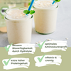 Photography: Two creamy oat drinks in glasses with mint and blue straws on a light background with oat flakes next to the glasses.